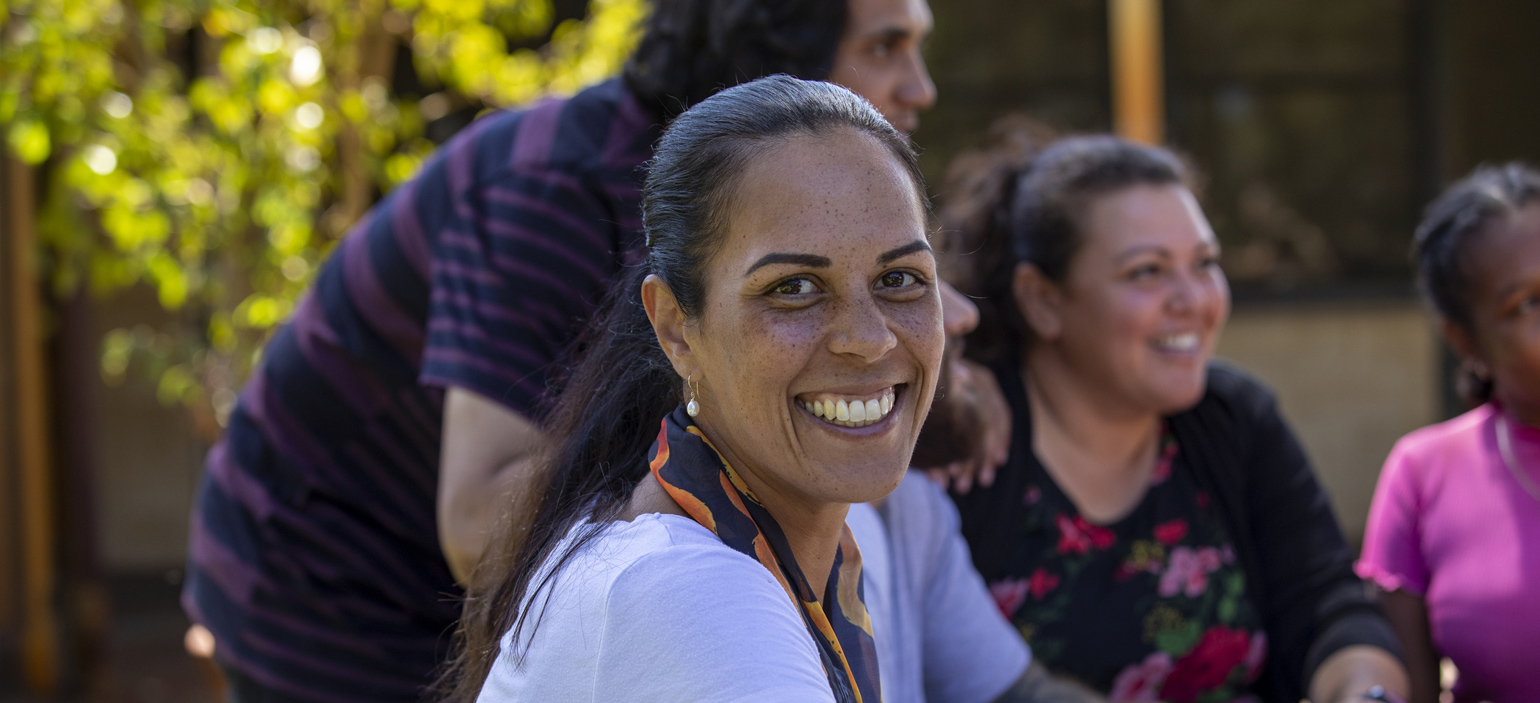 Woman smiling in a mixed race group