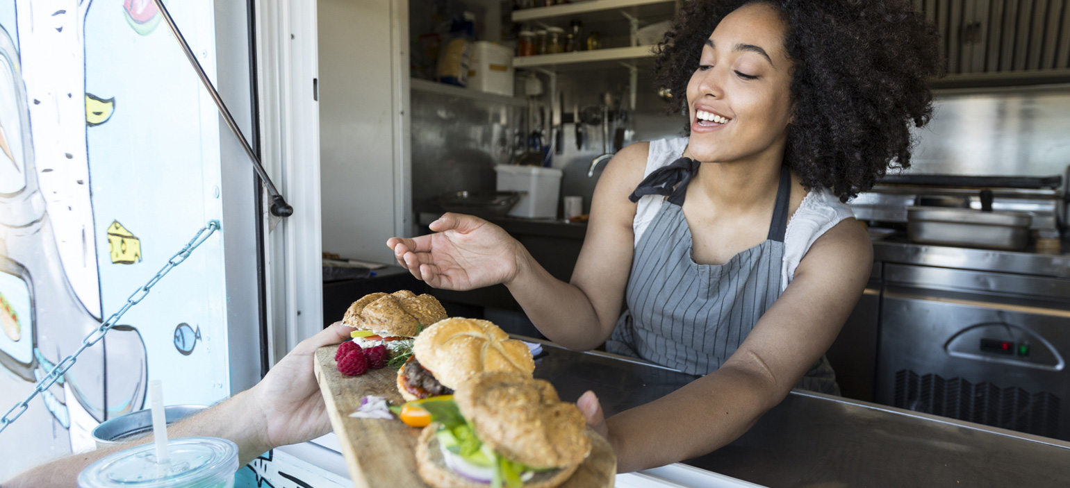 woman serving from food truck